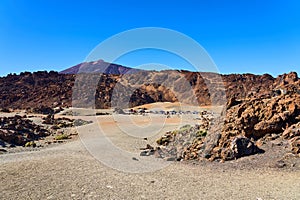 Parking modern cars in the desert at the foot of the volcano