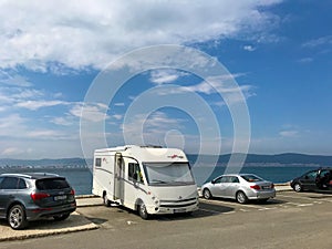 Parking motorhome near to the Black Sea in the parking lot at the entrance of Nessebar resort, Bulgaria