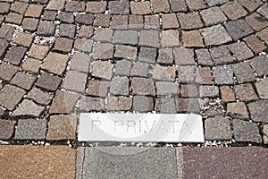 Parking paved with setts. Granite stones regular quarried pavement. photo