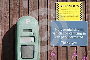 Parking pay machine and no overnight camping sign