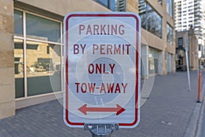 Parking By Permit Only Tow-Away sign with arrows in downtown Austin Texas