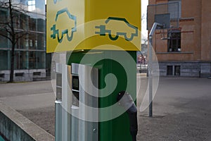 Parking place with charging stations for electric cars in green and yellow colors.