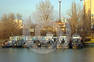 Parking of river tugs in the river port. Boats are side to side to each other