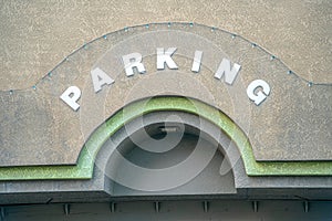 Parking sign on the wall above the arched entrance at downtown Tucson, Arizona