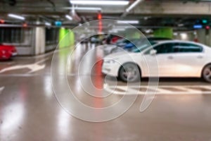 Parking space blurred. Empty road asphalt background in soft focus. Car lot parking space in underground city garage. Hidden