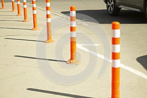 Parking stops. Orange posts in the parking lot