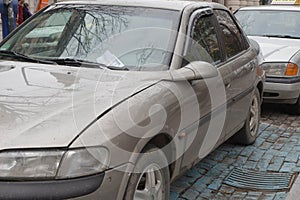 Parking ticket placed under windshield wiper of a car