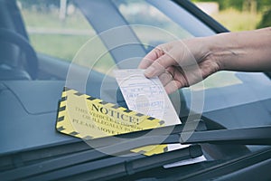 Parking ticket under windshield wiper