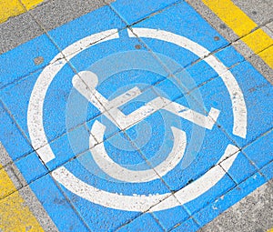 Parkingspace for disabled with wheelchair symbol on street floor