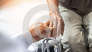 Parkinson`s disease patient, Arthritis hand pain or mental health care concept with geriatric doctor consulting examining elderly