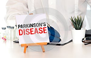 Parkinson& x27;s disease text on paper with heart beat diagram