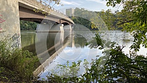 Parkland with bridge and water reflections. photo