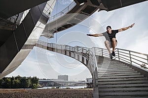 Parkour athlete doing a beautiful high jump from the stairs