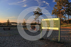 Parks Canada Sign for Gulf Islands National Park at Sidney Spit in Evening Light, British Columbia photo