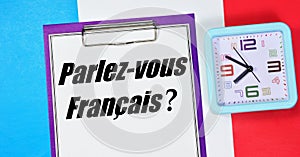 Parlez - vous franÃÂ§ais ? The inscription on the notebook is in French.