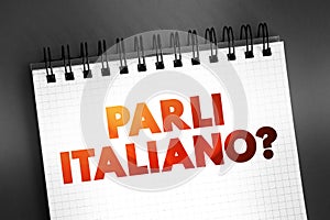 Parli Italiano? (do you speak Italian?) text quote on notepad, concept background