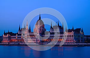 The Parliament in Budapest by the Danube. white stone facade at blue hour