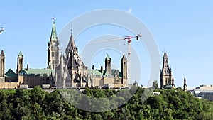 Parliament of Canada under renovation and Ottawa river in summer.