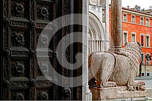 Parma, detail of the entrance with ancien lion sculpture, romanic cathedral in the duomo square