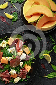 Parma ham and melon salad with mozzarella, green leaves mix