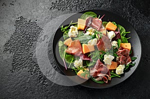 Parma ham and melon salad with mozzarella, green leaves mix