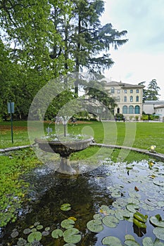 Parma, Italy: Fondation Magnani Rocca. Beautiful building of museum across garden and fountain with waterlilies photo