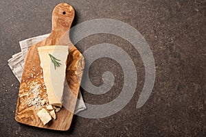 Parmesan cheese on wooden cutting board