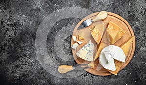 Parmesan. Cheeses set dor blu chedar camamber brie. Different types of cheese with knife on a dark background. Long banner format