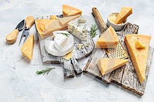 Parmesan. Cheeses set dor blu chedar camamber brie. Different types of cheese with knife on a light background. Long