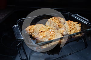 Parmesan crusted chicken breast being cooked fresh from the oven