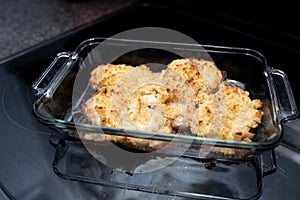 Parmesan crusted chicken breast being cooked fresh from the oven