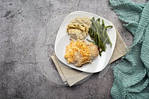 Parmesan crusted chicken breast with green beans and risotto