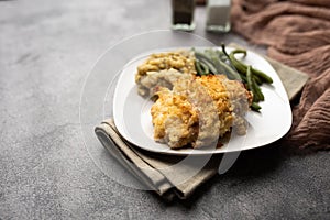 Parmesan crusted chicken breast with green beans and risotto