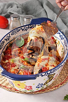 Parmigiana is an appetizer made from baked eggplant, cheese, garlic and tomato sauce. Traditional Italian dish in