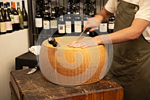 Parmigiano Reggiano Italian cheese cutting procedure photo