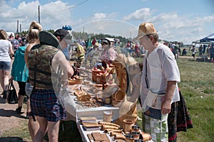 Trade in Souvenirs from birch bark at the fair during the ethnic festival Karatag on the shore of a Large lake