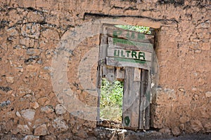 Parody pub door on abandoned building photo