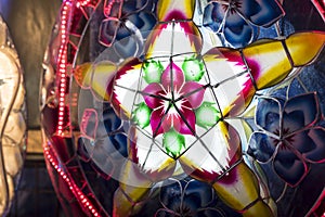 A Parol for sale at a stand at nighttime. A Filipino ornamental lantern displayed during the Christmas season. Made with capiz