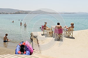 Paros, Greece, 10 August 2015. Local people and tourists enjoying their vacations at Arodo beach in Paros island.