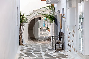 Paros island, Greece. Naousa old town. Whitewashed building, empty narrow cobblestone alley