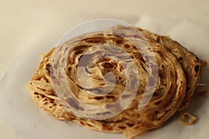 Parotta or Porotta is a layered flatbread made from Maida or Atta, alternatively known as flaky ribbon pancake. It is a favourite