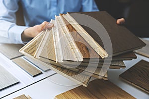 Parquet floor - store salesman with flooring samples in hands