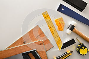 Parquet installer material and tools background on white table top