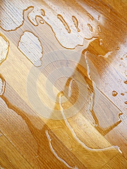 Parquet. Water drops on wooden surface.