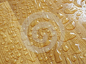 Parquet. Water drops on wooden surface.