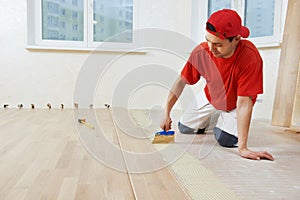 Parquet worker adding glue on floor