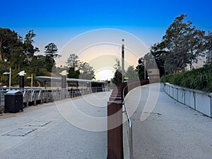 Parramatta River walkway lined with trees Ferry Wharf and High rise residential appartments on Parramatta River