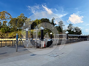 Parramatta River walkway lined with trees Ferry Wharf and High rise residential appartments on Parramatta River