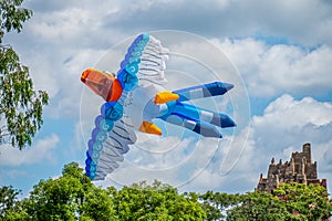 Parrot shaped Kite flying through the air