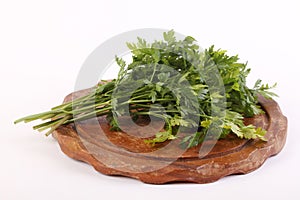 Parsley on a wooden plate